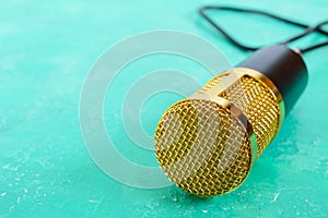 Beautiful golden microphone on a bright background, copy space, close up