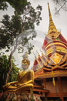 Beautiful golden pagoda with decorative Thai style fine art at public Buddhist Wat Phu Phlan Sung temple, Nachaluay, Ubon Ratchath