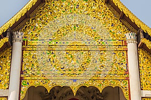 Beautiful golden patterned background on the Buddhist church gable end. Close up golden pattern background crafted on the gable in