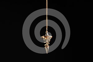 Beautiful golden pendulum with chain on black background. Hypnosis session