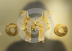 Beautiful golden pieces of a cacique representating a jaguar with nose ring and ear expansions