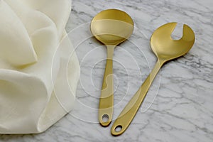 Beautiful golden serving spoon and fork