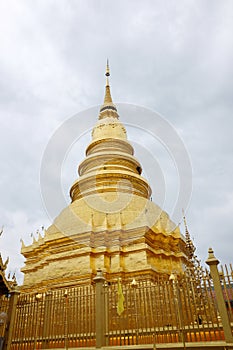 beautiful golden stupa at Wat Phra That Haripunchai temple at Lamphun province, Thailand