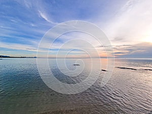 beautiful golden sun light sunrise in morning sea behind island. Fresh air and calm romantic place in thailand