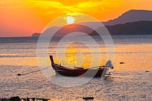beautiful golden sunrise above fishing boats in Rawai sea