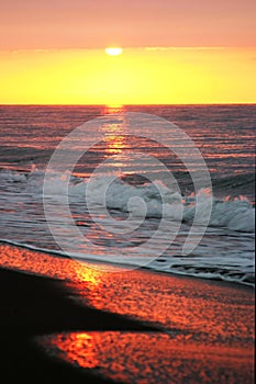 Beautiful golden sunrise as seen from the sandy beach in Marbella