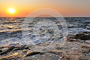 Beautiful golden sunset over Black sea rocky coastline in Crimea