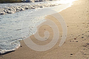 Beautiful golden sunset on the sea shore and textured sand