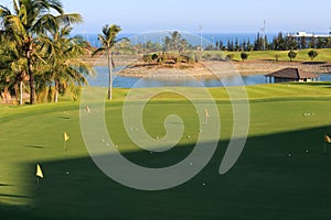 Golf course at the ocean side at sunset