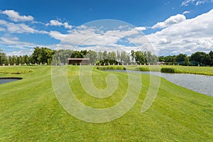 Beautiful golf course with perfect grass and water hindrance at