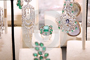 Gorgeous expensive ring with emeralds and diamonds