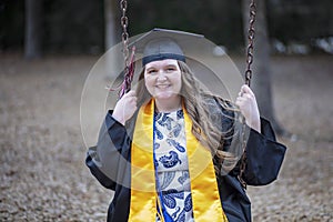 Beautiful Graduate Reminisces on the Playground of Her Elementary School