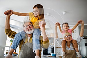 Grandchildren having fun at home while playing with their grandparents