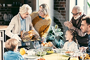 beautiful grandmother carrying turkey for family