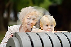 Beautiful granny and her little grandchild together in park