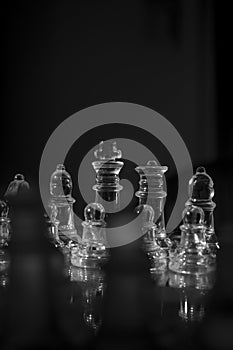 Beautiful grayscale closeup shot of clear glass chess pieces-perfect for mobile wallpapers