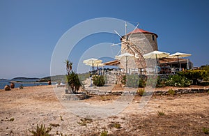 A beautiful Greek cafe building in the form of a mill to attract tourists in the summer season to the island of Kastos