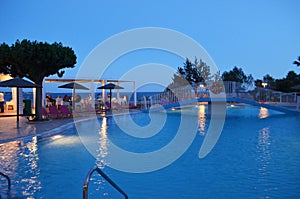 A beautiful Greek evening by the pool photo