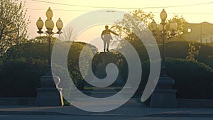 Beautiful green alley and bushes in the city street. Stock footage. Rear view of a monument surrounded by summer