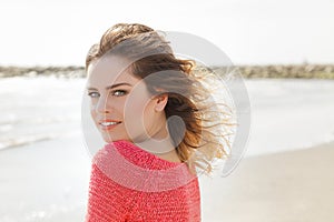 Beautiful green eyes woman smiling on a windy day