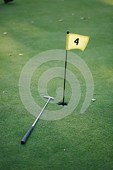 Beautiful green field golf grass and hole with flag