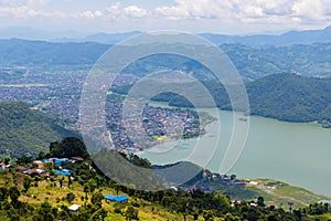 Beautiful Green Phewa Lake with Boats and Green Mountains in Pokhara City of Nepal during monsoon