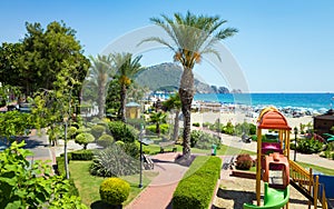 Beautiful green seafront, comfortable beach and clear blue sea in seaside resort city Alanya, Turkey