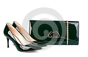 Beautiful green shoes with clutches on white isolated