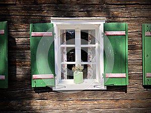 Beautiful green shutters and white window on typical and traditional austrian alpine wooden house - Salzkammergut