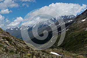 Beautiful green valley with covered snow mountain peaks