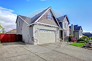 Beautiful grey house exterior with stone and driveway.