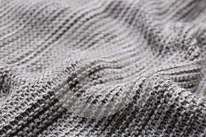 Beautiful grey knitted fabric as background, closeup