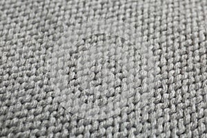 Beautiful grey knitted fabric as background, closeup
