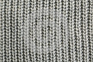Beautiful grey knitted fabric as background, top view