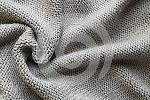 Beautiful grey knitted fabric as background, top view