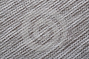 Beautiful grey knitted fabric as background, top view