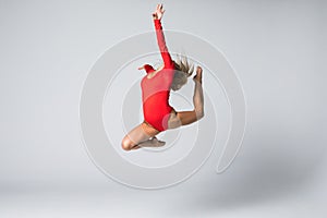 Beautiful gymnastic or dancer woman posing on white isolated background