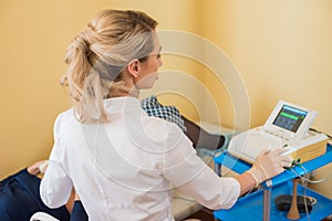 Beautiful gynecologist does cardiotocography of the fetus. A young doctor examines a patien. Checkup.