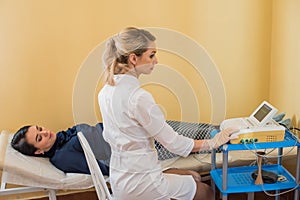 Beautiful gynecologist does cardiotocography of the fetus. A young doctor examines a patien. Checkup.