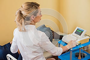 Beautiful gynecologist does cardiotocography of the fetus. A young doctor examines a patien. Checkup.