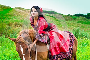 Beautiful gypsy girl riding a horse