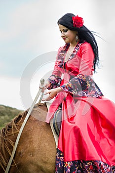 Beautiful gypsy girl riding a horse