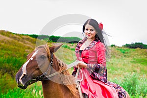 Beautiful gypsy girl riding a horse