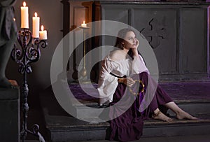 Beautiful gypsy woman closeup in the dark room of cathedral church