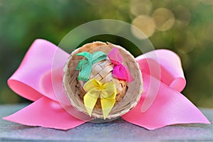 Beautiful hair arrangement with pink ribbon and mini straw hat with colorful ribbons