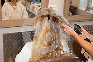 Beautiful hairstyle of young woman after dying hair and making highlights in hair salon for haridresser wedding bride day