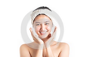Beautiful half naked model young woman preparing applying cosmetic cream treatment on her face isolated on white background.