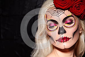 Beautiful Halloween Make-Up Style. Blond Model Wear Sugar Skull Makeup with Red Roses. Santa Muerte concept