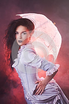 Beautiful Halloween vampire woman aristocrat with lace-parasol