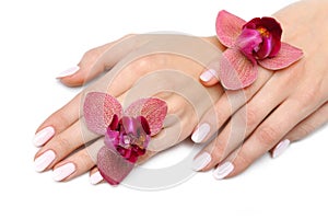 Beautiful hand with nail manicure and orchid